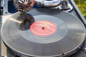 Moscow, Russia, 09.10.2017. A record player is spinning a record with the letters CC on it photo