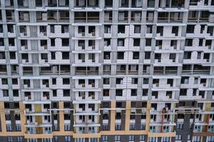 A large building with many windows and a lot of scaffolding photo