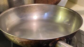 A captivating sequence of water being poured into a frying pan, emphasizing everyday cooking techniques video