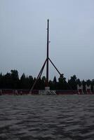 Beijing, China, 14.07.2010. A tall pole with a flag on top stands in a field photo
