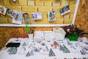 Grodno, Belarus, 03.01.2025 A table with a white tablecloth and a Christmas tree pattern photo