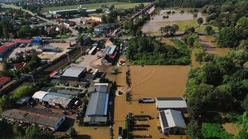 Aerial view of flooded railway tracks and buildings in industrial zone after heavy rain. Concept of natural disaster, climate impact and emergency video