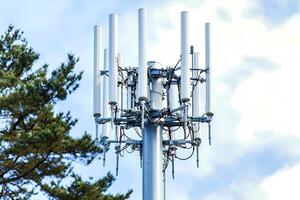 Telecommunication tower providing wireless network coverage on cloudy day photo
