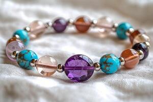 Colorful gemstone bracelet resting on soft white cloth photo