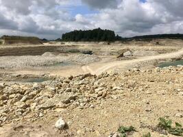 Works in a quarry with sand and fossils with a beautiful background photo