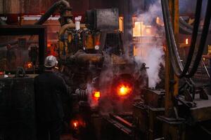 Iron pipe centrifugal pipe casting machine at the foundry.. photo