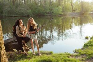 Smiling hikers by the lake with trekking poles, enjoying springtime adventure in the forest. photo
