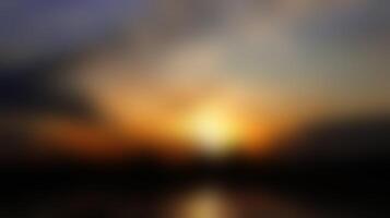 Abstract Sunrise Blurred Image with Dark Clouds and Golden Light photo
