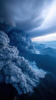 Smoke plumes rise over burning mountain range, creating dramatic scene photo