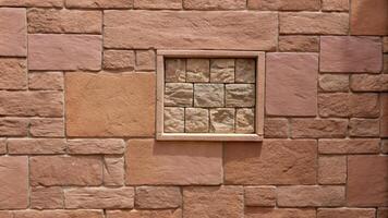 Textured stone wall with a small decorative relief. photo
