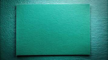 Textured teal rectangular panel on a dark background. photo