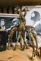 Moscow, Russia, 14.07.2025 Figure of hugging giraffes stands on book shelf photo
