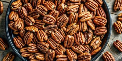 Close-up of a pile of fresh pecans in a rustic setting. photo