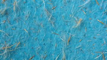 Textured blue handmade paper with embedded fibers. photo