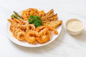 deep fried seafood with mix vegetable on white plate photo