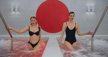 Two Beautiful Women Relaxing In SPA, Going Out From Pool With Bubbling Water, Hydrotherapy video