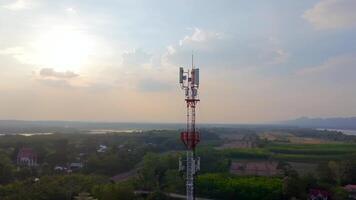 telecommunication tower, Aerial view of a telecommunication tower at sunset with countryside landscape in the background, symbolizing wireless communication and rural infrastructure video