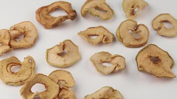Dried apple slices arranged on a plain surface highlighting their natural textures and shapes video