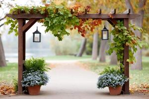 Wooden arch with hanging lanterns illuminating a path in a park during autumn photo