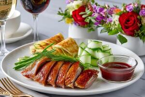 Peking duck served with cucumber, pancakes and hoisin sauce photo