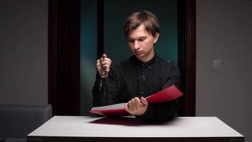 Priest reading holy book and holding rosary beads video