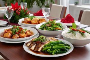 Christmas dinner table setting with delicious vietnamese dishes featuring fried fish and tofu photo