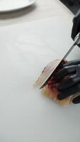 Chef slicing vacuum-packed smoked fish fillet video