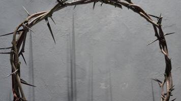 Jesus Crown of thorns projecting shadowy silhouette against textured gray surface, symbolizing spiritual pain and redemptive struggle good friday for Christian background, Easter concept video