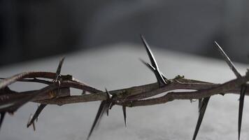 Crown of thorns resting on a surface Easter concept, representing the suffering and sacrifice of Jesus Christ 4k video