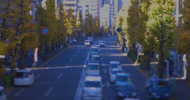 A miniature traffic jam at city street with yellow leaves in Tokyo in autumn video