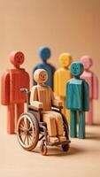 wheelchair user surrounded by multicolored wooden figures promoting diversity and inclusion photo