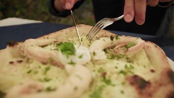 Man Cutting A Slice Of Pizza With Octopus With Fork And Knife video
