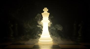 Illuminated Chess King Piece on Chessboard with Mystical Smoke Effect photo