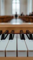 A close-up of piano keys with a blurred background featuring wooden pews. Soft natural light filters through large windows, creating a tranquil atmosphere. photo