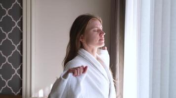 woman waking up, open window curtains and stretching in the morning video