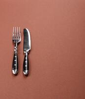 Knife and fork, cutlery on a dining table photo