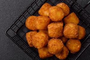 Cheese or potato croquettes fried in breading with salt, spices photo