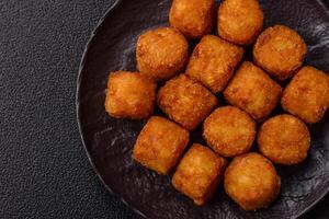 Cheese or potato croquettes, balls fried in breading with salt photo