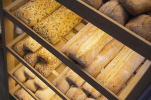 Fresh cereal bread on store shelves photo