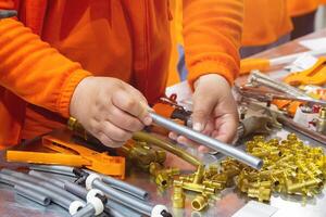 Master demonstrates components for installation of cross-linked polyethylene water pipes photo