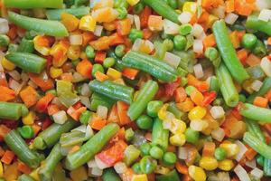 Colorful mix of vegetables is fried in a frying pan close-up photo