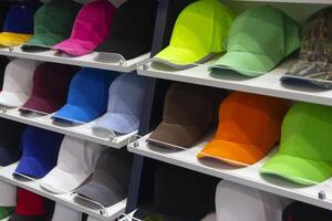 Colorful caps neatly displayed on shelves in an shop photo