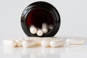 Probiotic Capsules Spilled from a Container photo