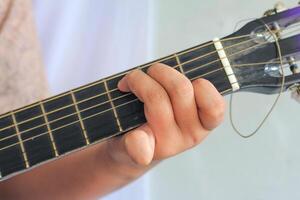 Guitarist Pressing Strings with Accurate Finger Placement Technique photo