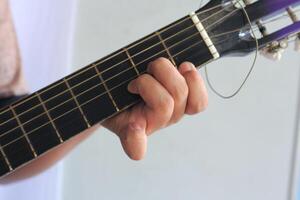 Musicians Fingers Press Guitar Strings for Chord Practice photo