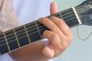 Hand Demonstrating Guitar Chord Technique on the Fingerboard photo