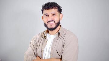 Confident man smiling with folded arms on white background video