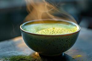 A cup of green tea with steam coming out of it photo
