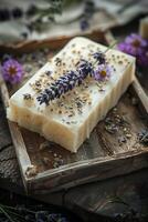 A bar of soap with lavender flowers on top photo
