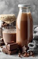 Chocolate Milk Bottle with Cap and Chocolate Pieces photo